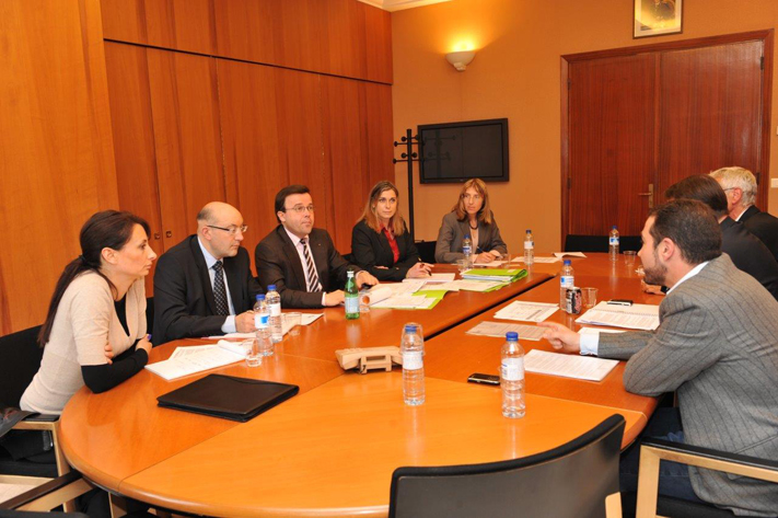 The Minister in a meeting with other departments. 