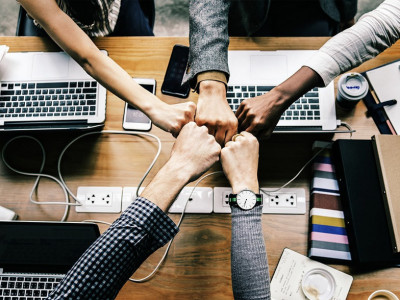 Young business people fist-bumping
