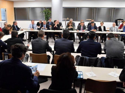 Members of the commission meeting around a table in Monaco