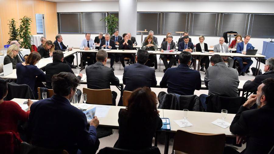 Members of the commission meeting around a table in Monaco