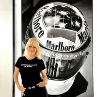 Vanessa von Zitzewitz standing in front of her photograph of Michael Schumacher's helmet