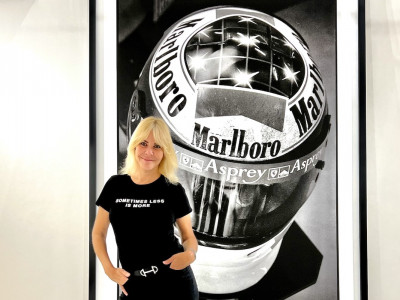 Vanessa von Zitzewitz standing in front of her photograph of Michael Schumacher's helmet