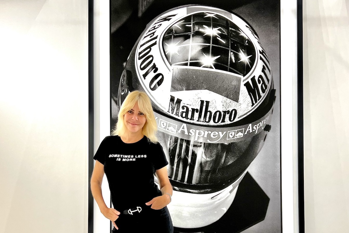 Vanessa von Zitzewitz standing in front of her photograph of Michael Schumacher's helmet