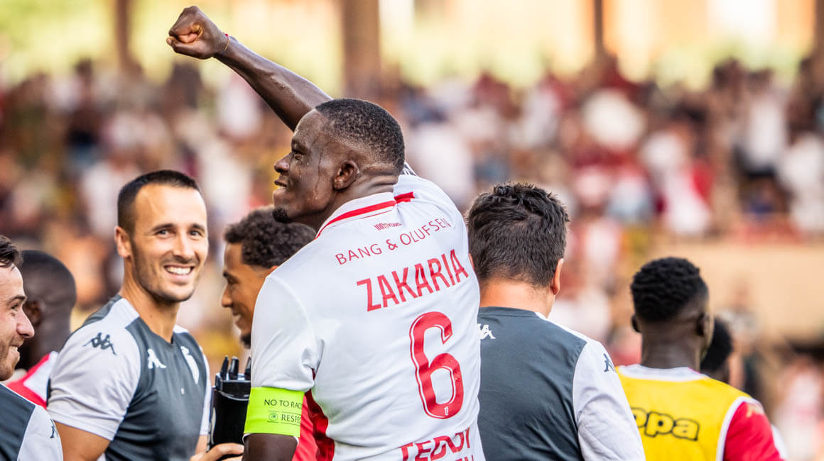 AS Monaco's Denis Zakaria celebrates by gesturing to the crowd at the Stade Louis II after giving his side a late lead against Lens