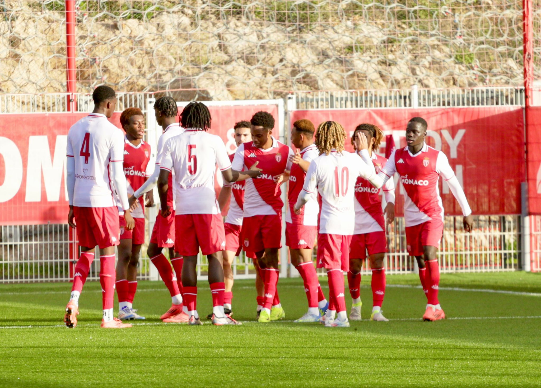 Monaco's academy celebrate Lucas Michal's winner against Benfica at the club's Performance Centre in La Turbie