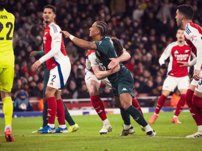 Monaco's Kehrer is grappled by an Arsenal player during the defeat to the Gunners at the Emirates