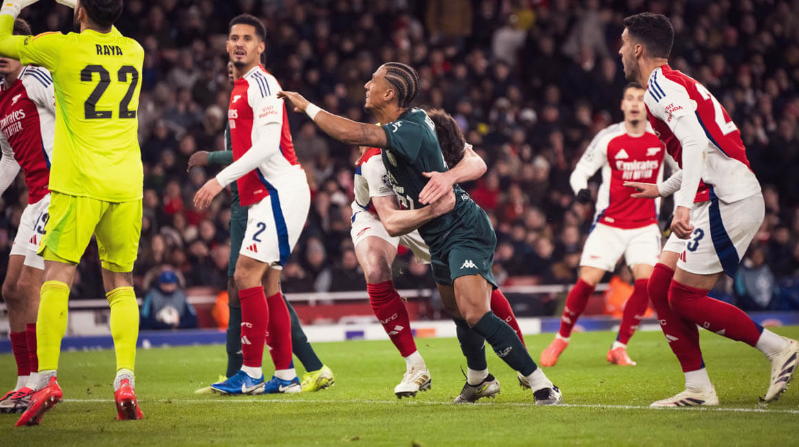 Monaco's Kehrer is grappled by an Arsenal player during the defeat to the Gunners at the Emirates