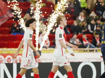 Mika Biereth walking ahead of Maghnes Akliouche after netting one of his three goals for Monaco against Reims