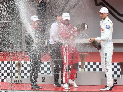 Rowland celebrating his victory by spraying champagne on the podium after the conclusion of the Monaco e-Prix